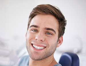 Smiling man with metal free dental restorations in dental chair