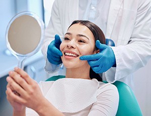 a patient sitting in a dental chair and smiling