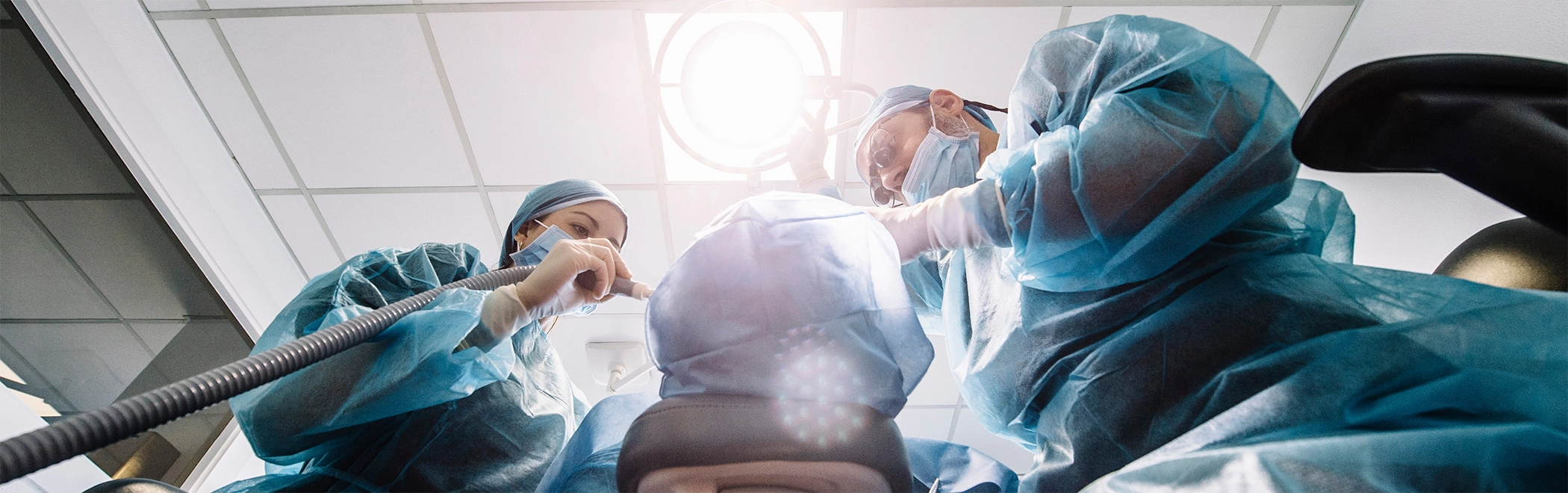 Dentist and assistant treating a patient