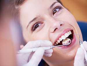 Woman receiving preventive dentistry checkup and teeth cleaning
