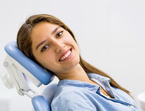 Patient smiling after successful dental implant salvage