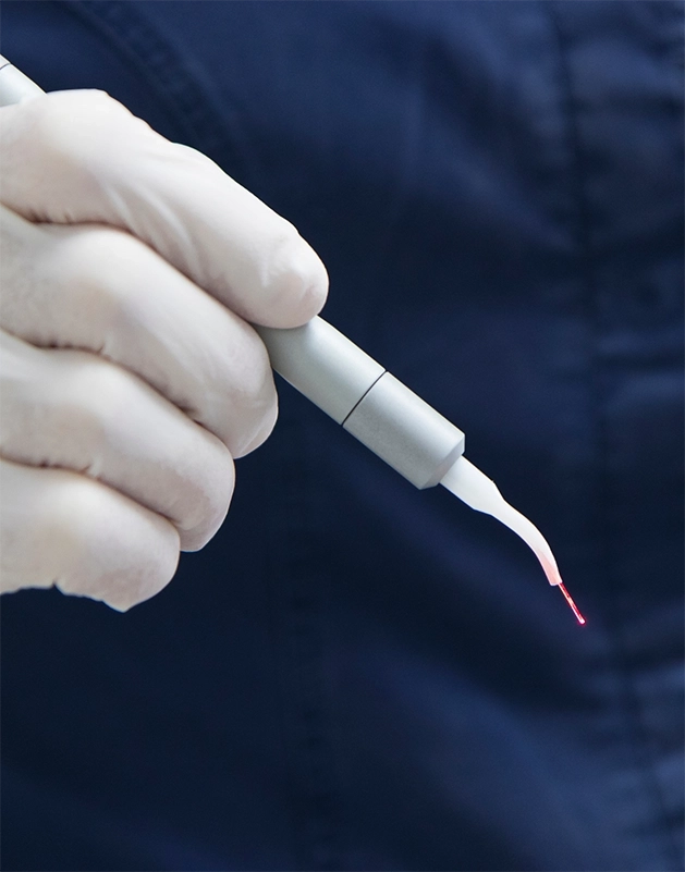 Dentist holding a pen-like dental laser device