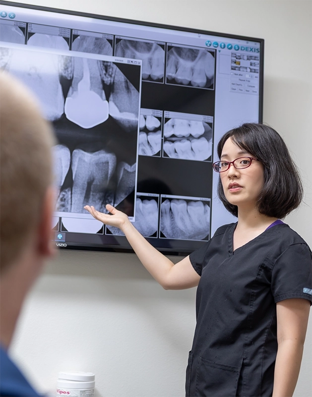 Doctor Cao showing a patient their dental x-rays
