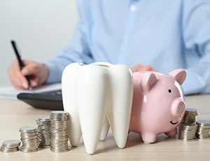 Coins next to a piggy bank