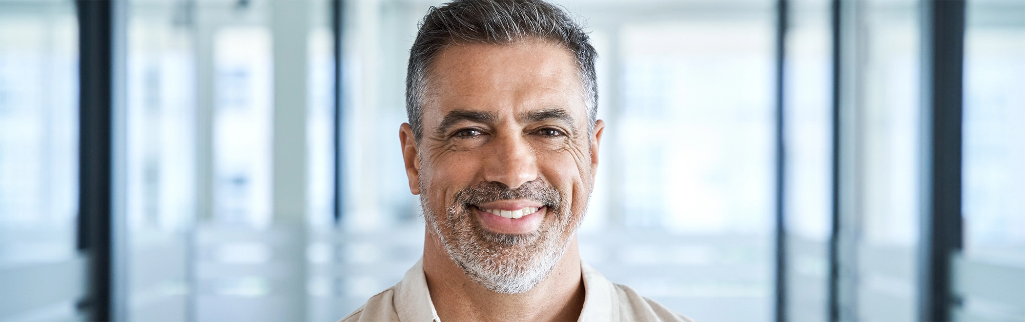 Older man smiling with a dental bridge in Richardson