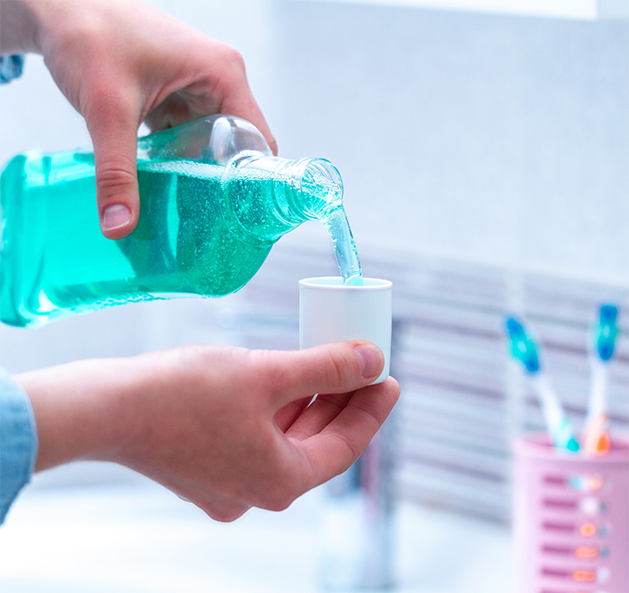 Person using mouthwash
