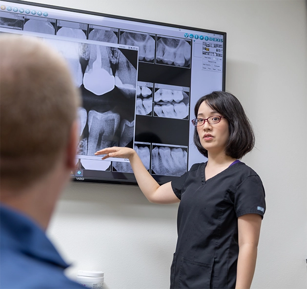Dentist showing a patient x-rays of their teeth