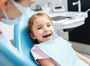 Happy little girl in dental treatment chair