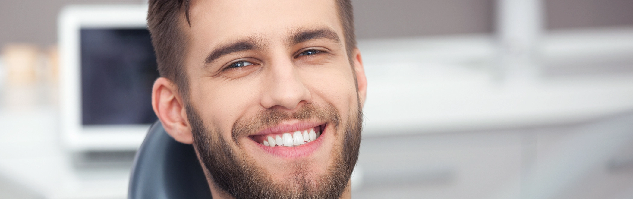 Young man smiling in the dental chair after teeth whitening in Richardson