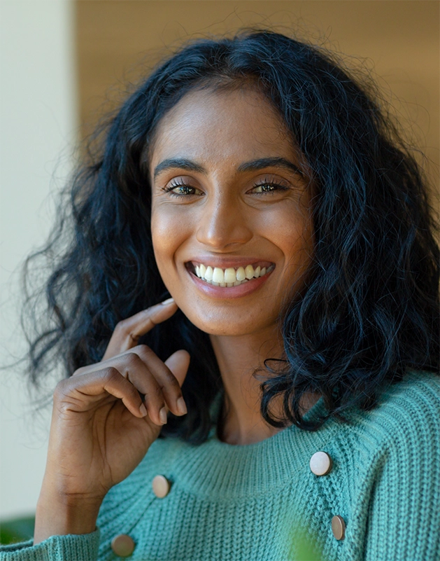 Smiling woman in a blue-green sweater