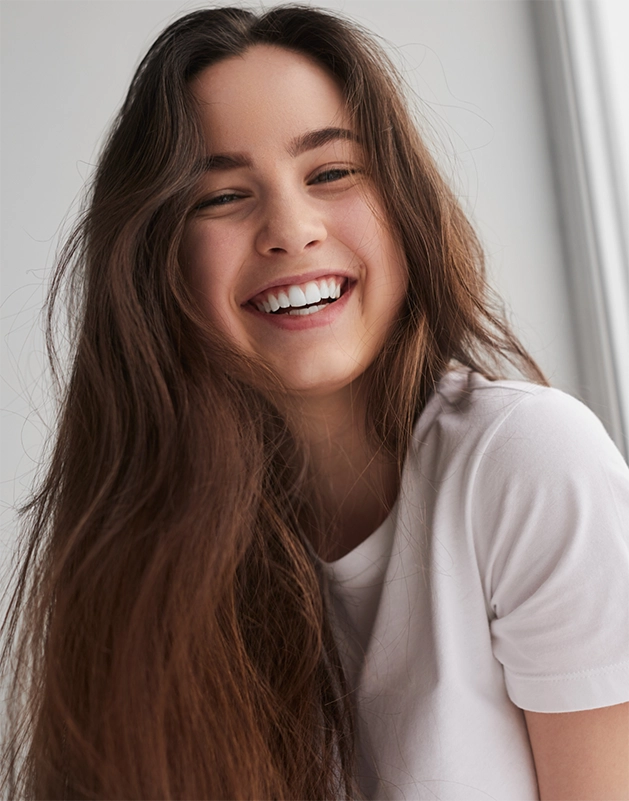 Young woman in a white T shirt grinning