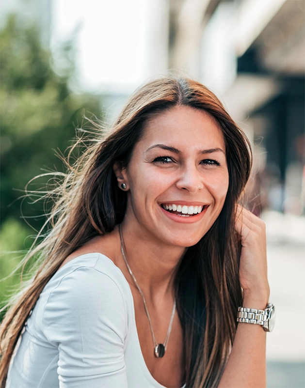 Brunette woman smiling outdoors