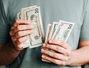 Close up of man’s hands counting cash