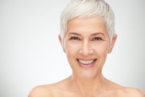 older woman with beautiful implant overdentures in richardson